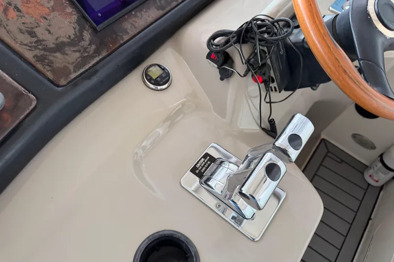 Slide: The Image of Control panel of 2003 Cruisers Yachts 405 Express Motoryacht with steering wheel and throttle. - 18