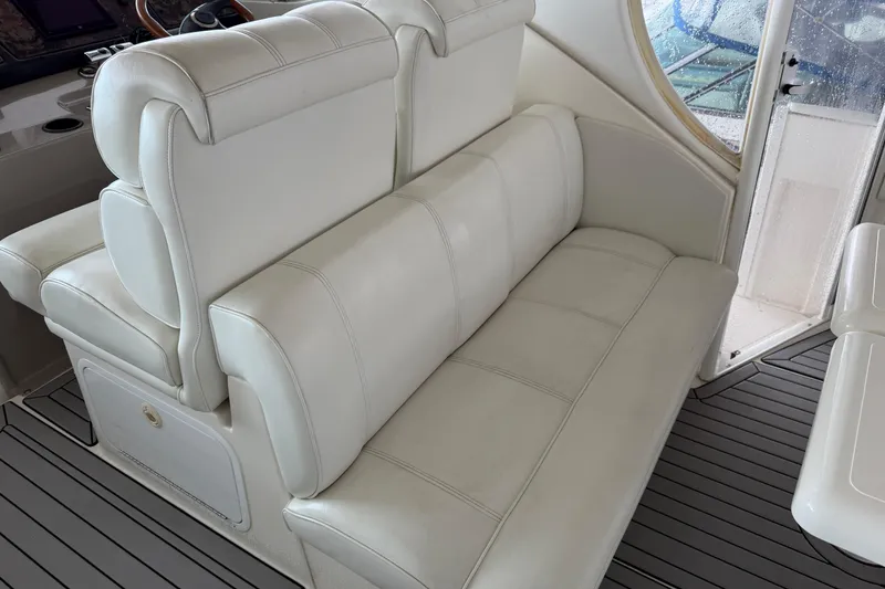 Slide: The Image of Luxurious white seating on 2003 Cruisers Yachts 405 Express Motoryacht, featuring elegant design and comfort. - 20