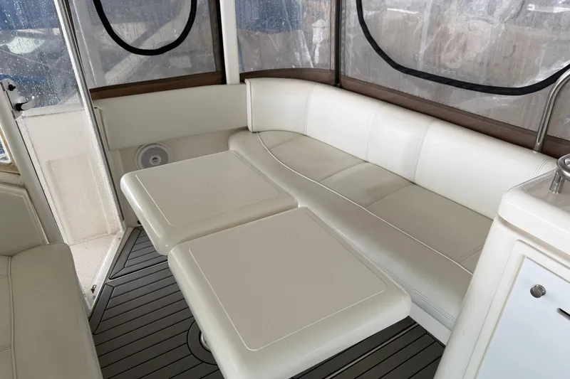 Slide: The Image of 2003 Cruisers Yachts 405 Express Motoryacht interior with white seating and table. - 21