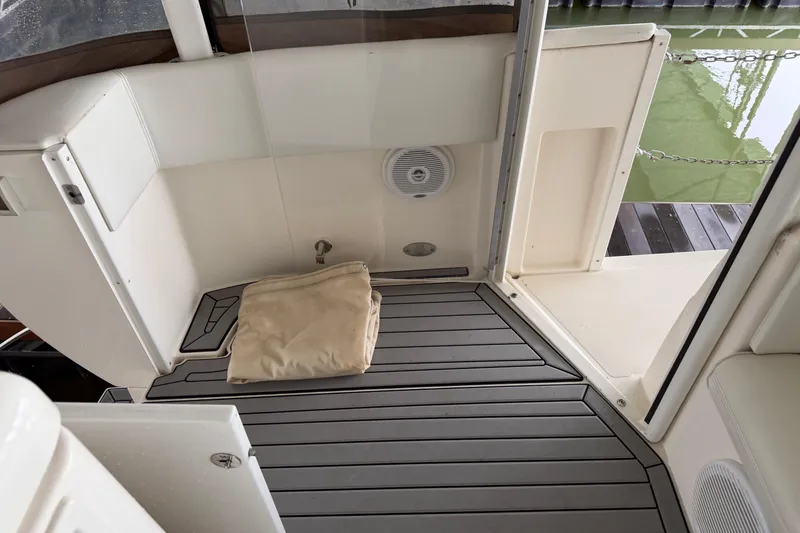 Slide: The Image of 2003 Cruisers Yachts 405 Express Motoryacht deck with beige cover and speaker. - 24