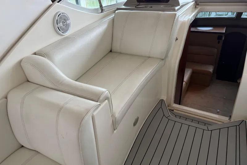 Slide: The Image of 2003 Cruisers Yachts 405 Express Motoryacht interior with white seating and cabin entrance. - 26