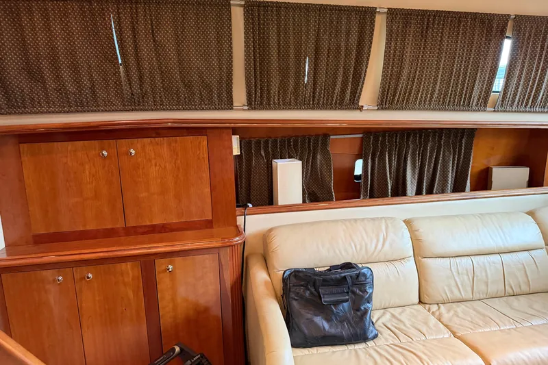 Slide: The Image of Interior of 2003 Cruisers Yachts 405 Express Motoryacht with leather seating and wooden cabinetry. - 30