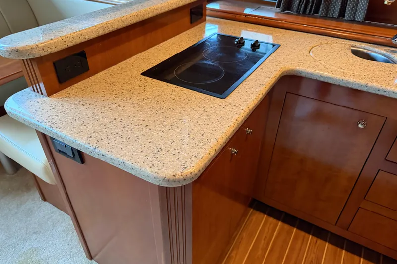 Slide: The Image of Luxurious kitchen area in 2003 Cruisers Yachts 405 Express Motoryacht with stovetop and sink. - 36