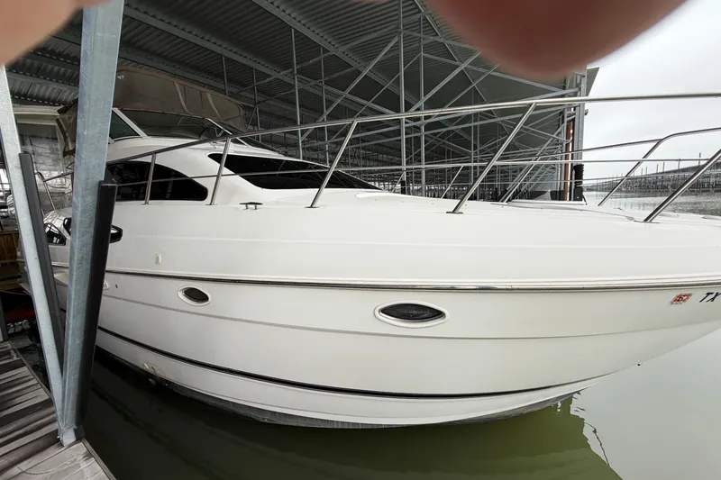 Slide: The Image of 2003 Cruisers Yachts 405 Express Motoryacht docked in a covered marina. - 4