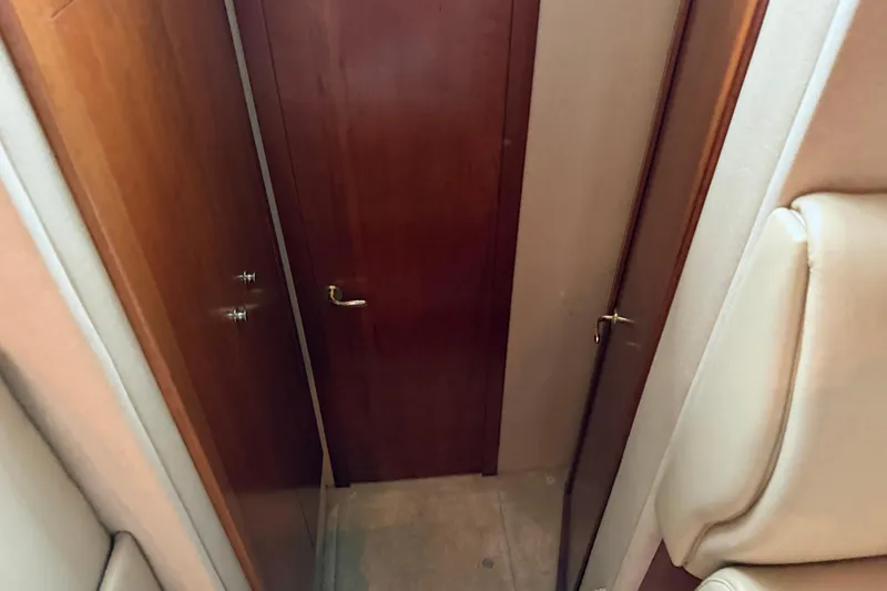 Slide: The Image of Interior view of 2003 Cruisers Yachts 405 Express Motoryacht with wooden doors and beige seating. - 40