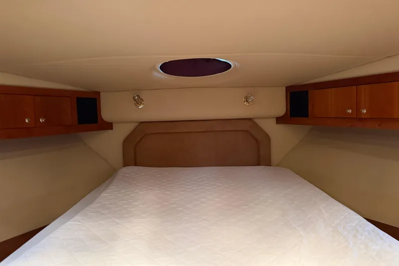Slide: The Image of Luxurious cabin interior of 2003 Cruisers Yachts 405 Express Motoryacht with cozy bed and wood cabinets. - 41
