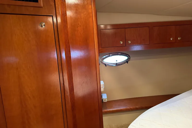 Slide: The Image of Interior of 2003 Cruisers Yachts 405 Express Motoryacht with wood cabinetry and porthole. - 42