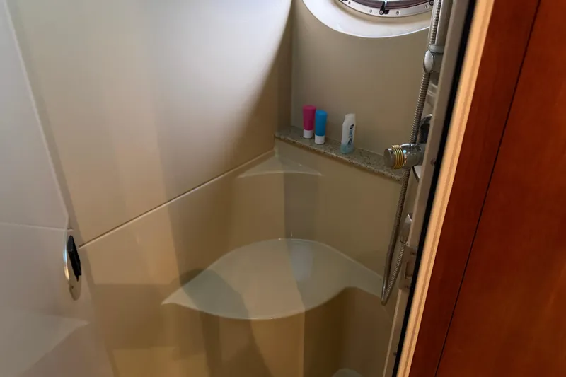 Slide: The Image of Shower area in 2003 Cruisers Yachts 405 Express Motoryacht with toiletries and porthole window. - 44