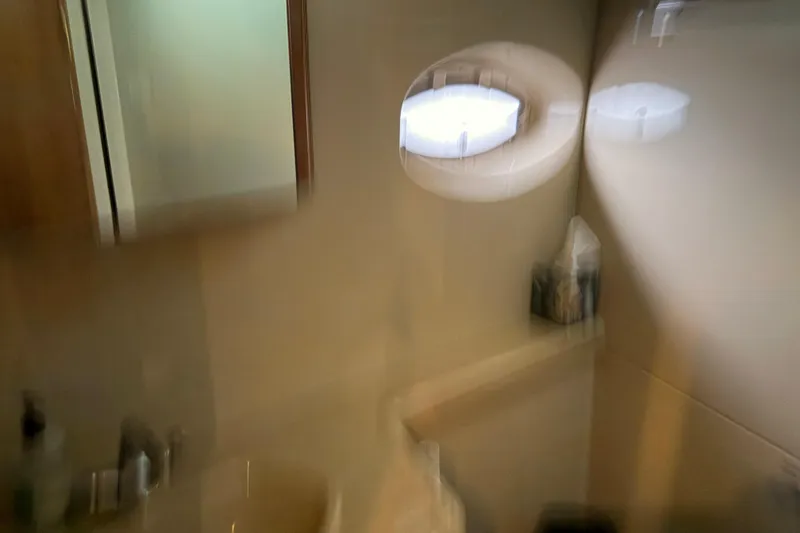 Slide: The Image of Blurry interior of 2003 Cruisers Yachts 405 Express Motoryacht bathroom with mirror and porthole. - 47