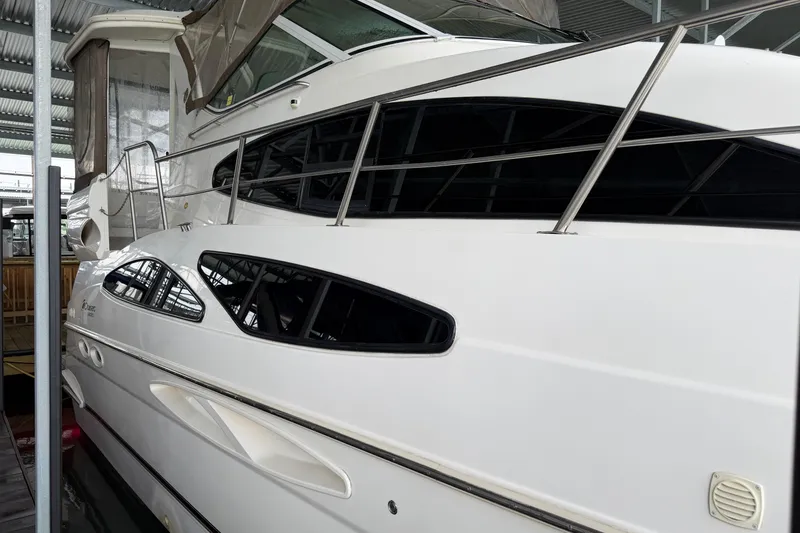Slide: The Image of 2003 Cruisers Yachts 405 Express Motoryacht docked in a covered marina. - 5