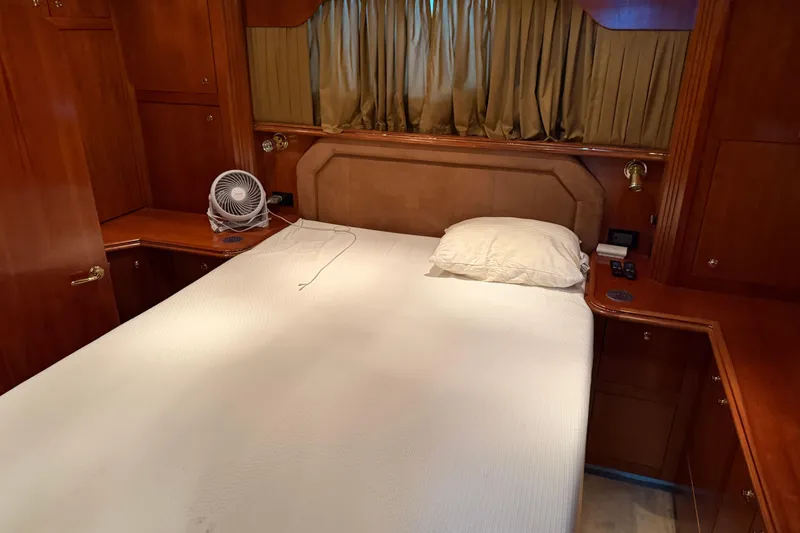 Slide: The Image of Luxurious cabin interior of 2003 Cruisers Yachts 405 Express Motoryacht with cozy bed and wooden furnishings. - 52