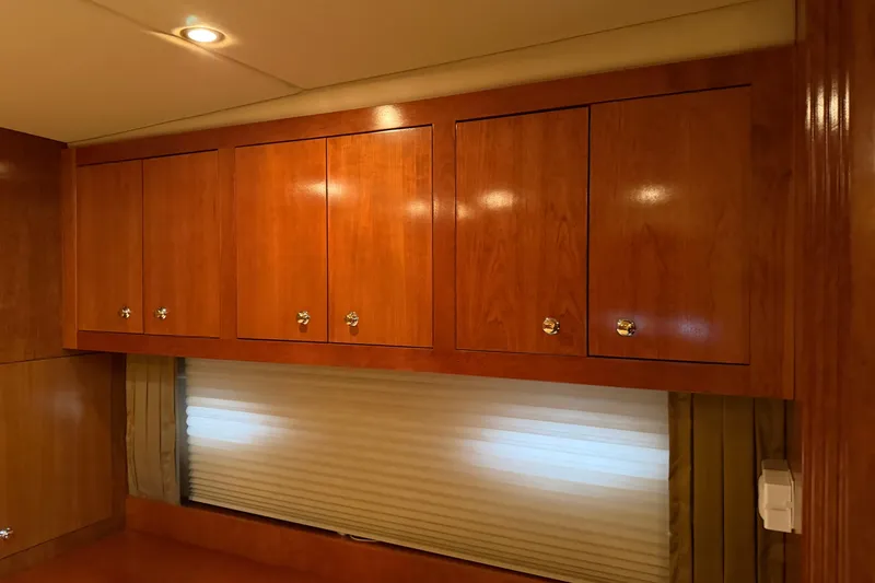 Slide: The Image of Wooden cabinets and window blinds inside a 2003 Cruisers Yachts 405 Express Motoryacht. - 54