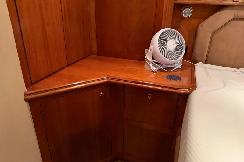 Slide: The Image of Wooden cabinet with a small fan in a 2003 Cruisers Yachts 405 Express Motoryacht interior. - 55