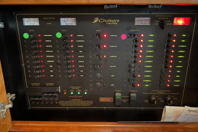 Slide: The Image of Control panel of a 2003 Cruisers Yachts 405 Express Motoryacht with various switches and indicators. - 61