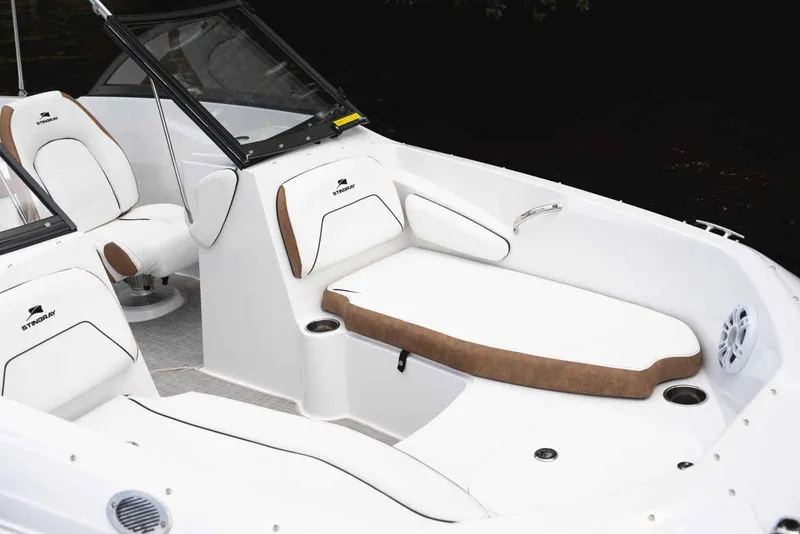 Slide: The Image of Manufacturer Provided Image: 2026 Stingray 191 DC boat interior with white and brown seating, cup holders, and speaker. - 4
