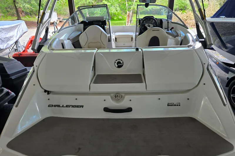Slide: The Image of 2011 Sea-Doo 180 Challenger SE boat, rear view, showcasing seating and steering area. - 10