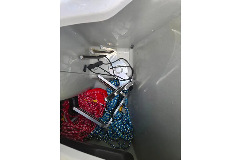 Slide: The Image of Storage compartment of 2011 Sea-Doo 180 Challenger SE with ropes and metal tools. - 11
