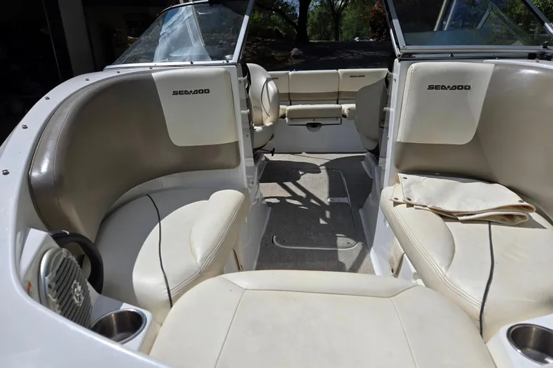 Slide: The Image of 2011 Sea-Doo 180 Challenger SE interior with beige seating and open cockpit design. - 4