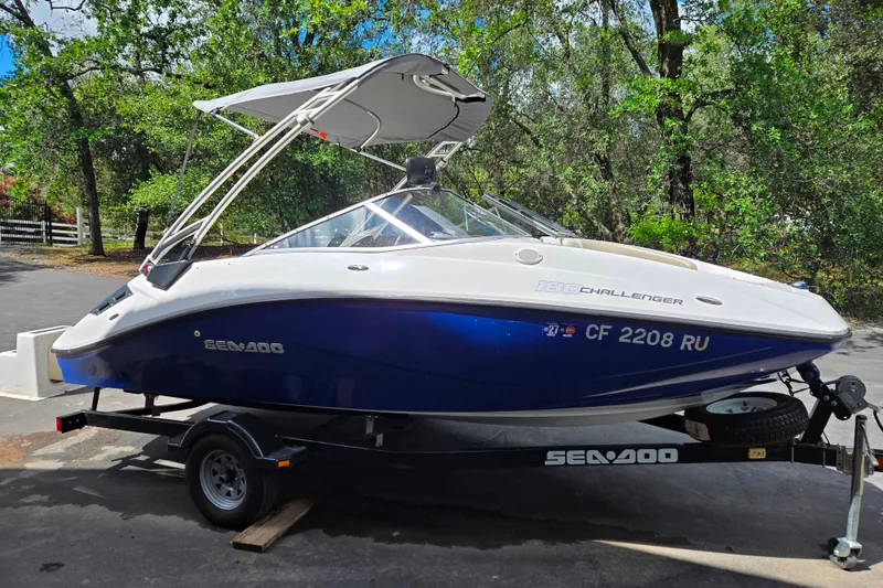 Slide: The Image of 2011 Sea-Doo 180 Challenger SE boat on trailer, parked outdoors. - 8
