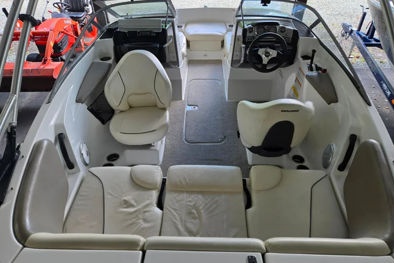 Slide: The Image of 2011 Sea-Doo 180 Challenger SE interior with seating and steering wheel, showcasing spacious design. - 9