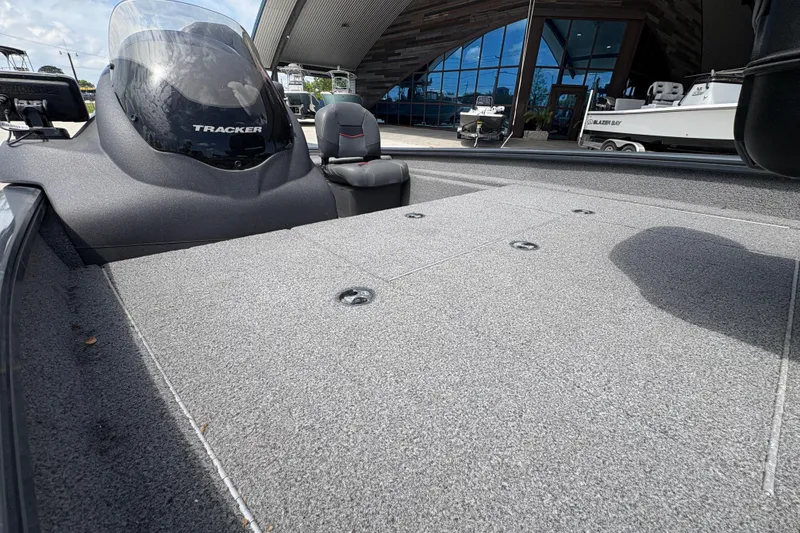 Slide: The Image of 2022 Tracker Pro Team 175 boat deck with windshield, parked outside showroom. - 13