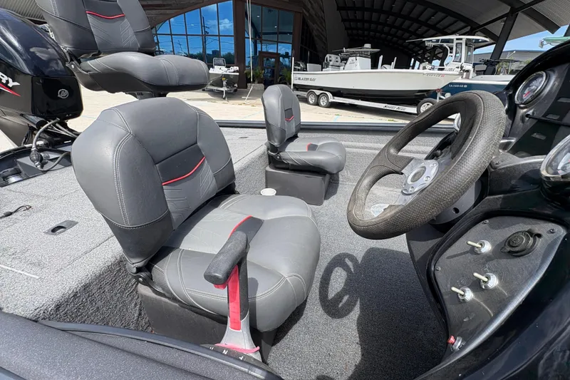 Slide: The Image of 2022 Tracker Pro Team 175 boat interior with steering wheel and seating. - 14