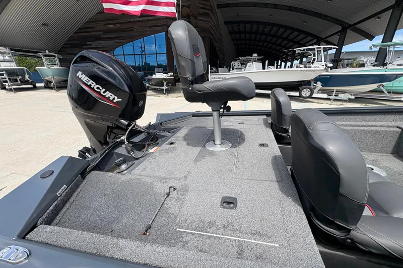 Slide: The Image of 2022 Tracker Pro Team 175 boat with Mercury engine, displayed in a showroom. - 16