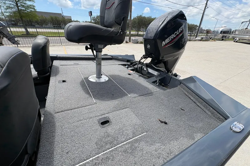 Slide: The Image of 2022 Tracker Pro Team 175 boat with Mercury engine, featuring a spacious carpeted deck. - 17