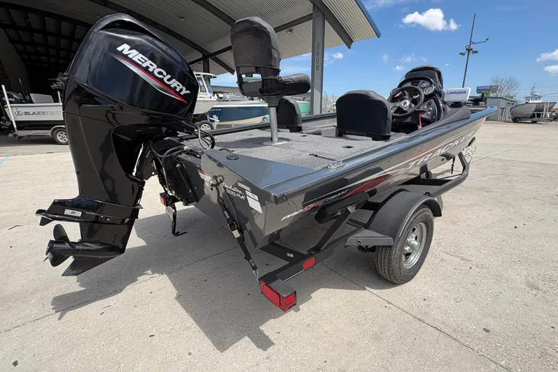 Slide: The Image of 2022 Tracker Pro Team 175 boat with Mercury engine, parked outdoors. - 4