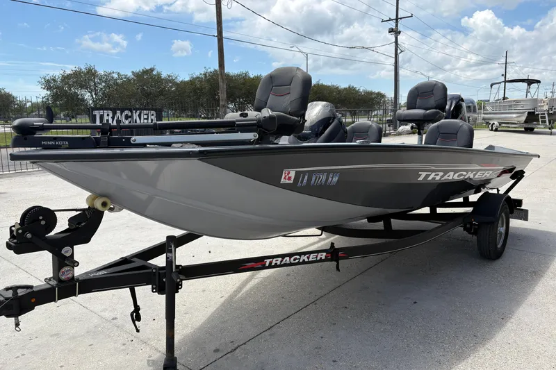 Slide: The Image of 2022 Tracker Pro Team 175 boat on trailer, parked outdoors under a cloudy sky. - 8