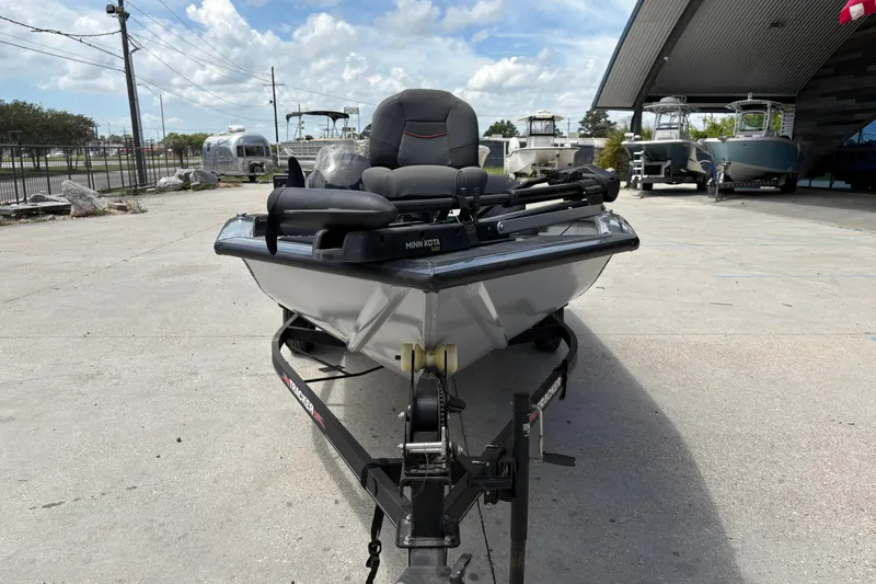 Slide: The Image of 2022 Tracker Pro Team 175 boat on trailer, parked outdoors under a cloudy sky. - 9
