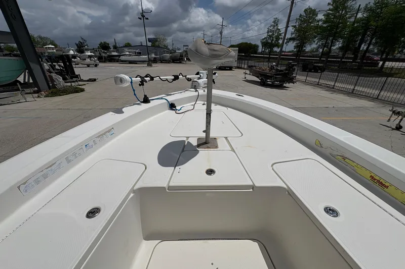 Slide: The Image of 2008 Hydra-Sports Bay Bolt 23 boat deck with fishing equipment, parked outdoors. - 16