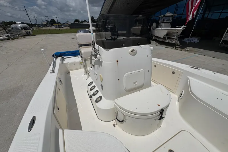 Slide: The Image of 2008 Hydra-Sports Bay Bolt 23 boat interior with seating and console, docked outdoors. - 17