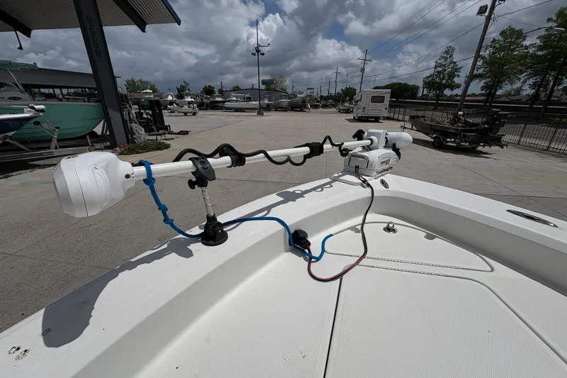 Slide: The Image of 2008 Hydra-Sports Bay Bolt 23 boat with mounted trolling motor in a marina setting. - 20