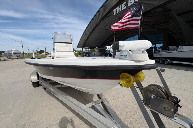 Slide: The Image of 2010 Blazer Bay 2020 boat on trailer with American flag, parked outside dealership. - 10