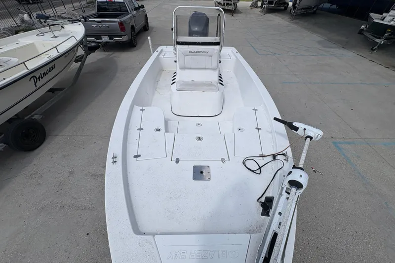 Slide: The Image of White 2010 Blazer Bay 2020 boat on trailer, parked beside a truck. - 11