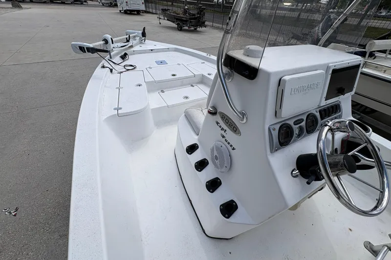 Slide: The Image of White Blazer Bay 2020 boat, 2010 model, featuring a steering console and navigation equipment. - 16