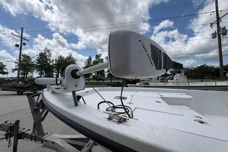 Slide: The Image of 2010 Blazer Bay boat with trolling motor under a cloudy sky. - 21