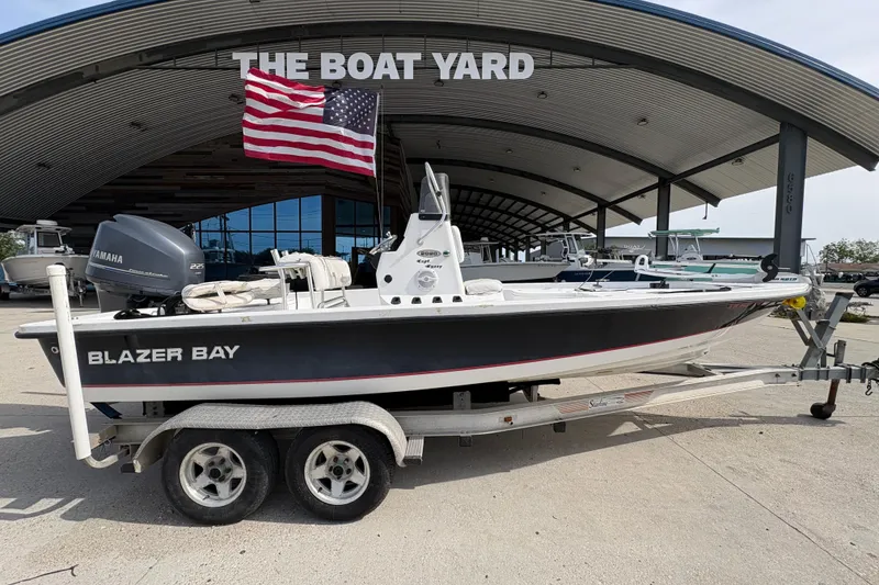 Slide: The Image of Blazer Bay 2020 boat on trailer at The Boat Yard, American flag displayed. - 3