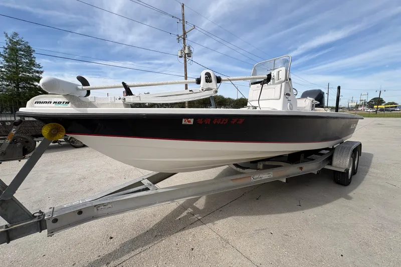 Slide: The Image of 2010 Blazer Bay 2020 boat on trailer, featuring Minn Kota trolling motor. - 8