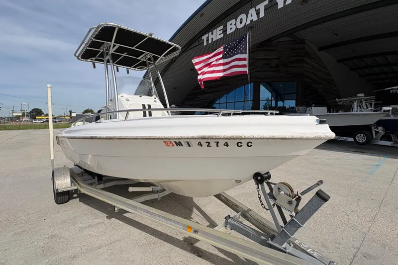 Slide: The Image of 2014 Glasstream 192 CC boat on trailer outside The Boat Yard, with American flag. - 10