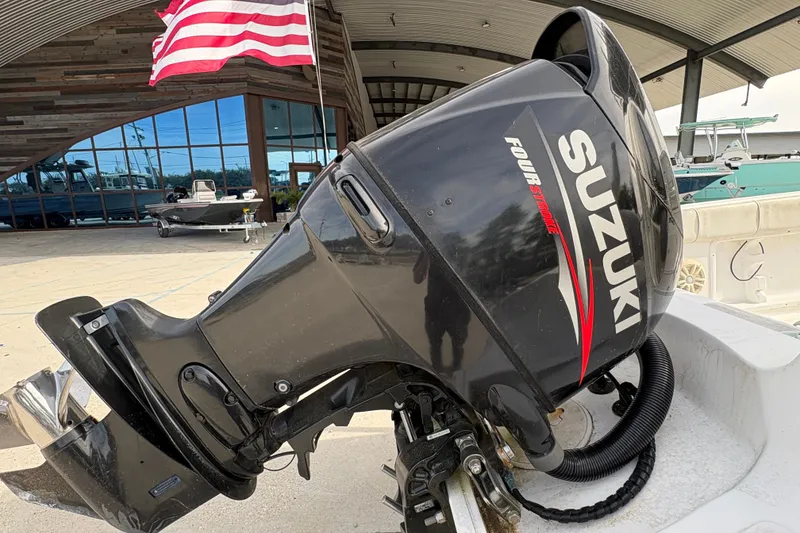 Slide: The Image of 2014 Glasstream 192 CC with Suzuki outboard motor, American flag in background. - 22