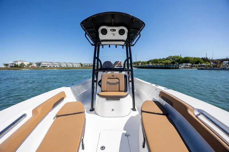 Slide: The Image of 2025 Sea Pro 202 Center Console boat on water, featuring spacious seating and modern design. - 11