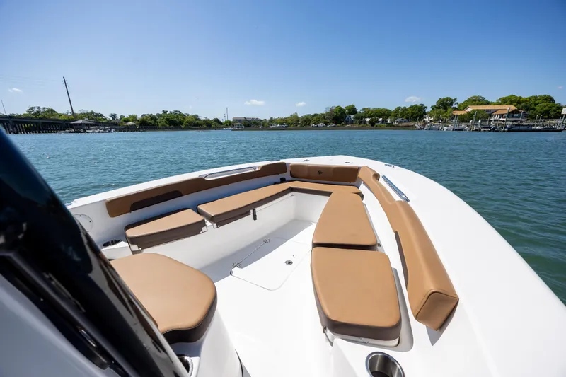 Slide: The Image of 2025 Sea Pro 202 Center Console boat with tan seating on calm water. - 13