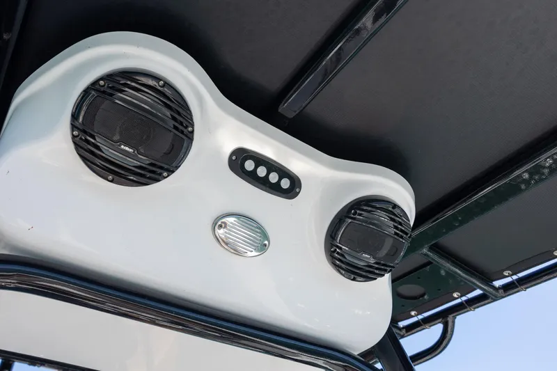 Slide: The Image of 2025 Sea Pro 202 Center Console boat speakers and control panel under canopy. - 14