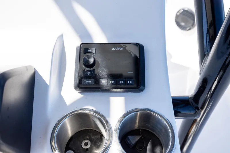 Slide: The Image of 2025 Sea Pro 202 Center Console audio control panel with cup holders. - 21