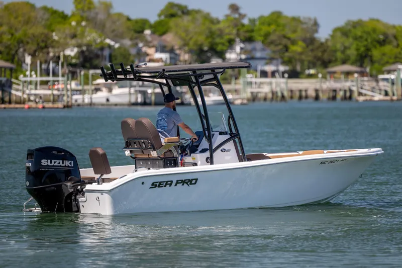 Slide: The Image of 2025 Sea Pro 202 Center Console boat cruising on a calm lake with Suzuki outboard. - 4