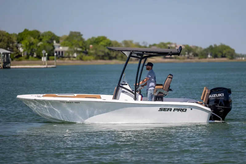 Slide: The Image of 2025 Sea Pro 202 Center Console boat cruising on a calm lake with a Suzuki engine. - 8