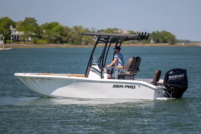 Slide: The Image of 2025 Sea Pro 202 Center Console boat cruising on a calm lake with Suzuki engine. - 9