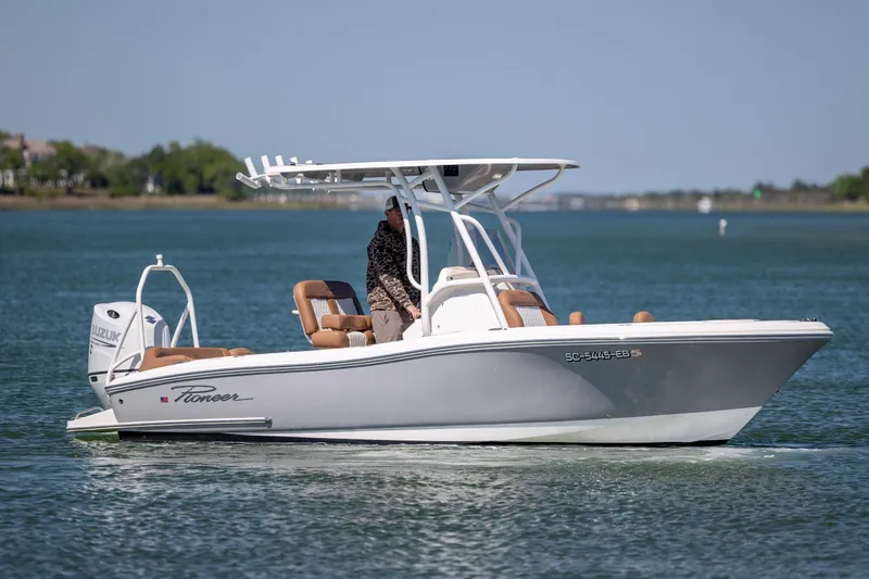 The Image of 2022 Pioneer 202 Islander boat cruising on a calm lake with a Suzuki engine. - 1